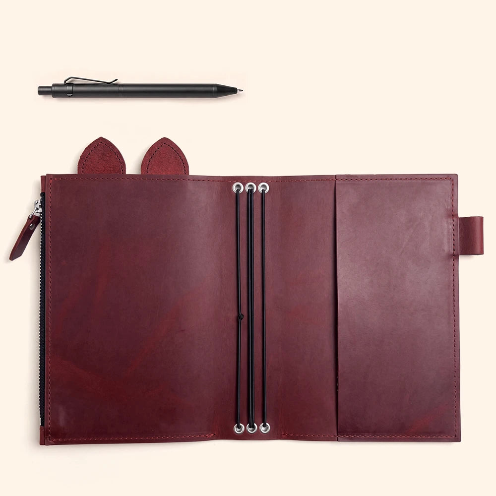 Open leather journal case with practical pen storage and carefully reinforced eyelets.