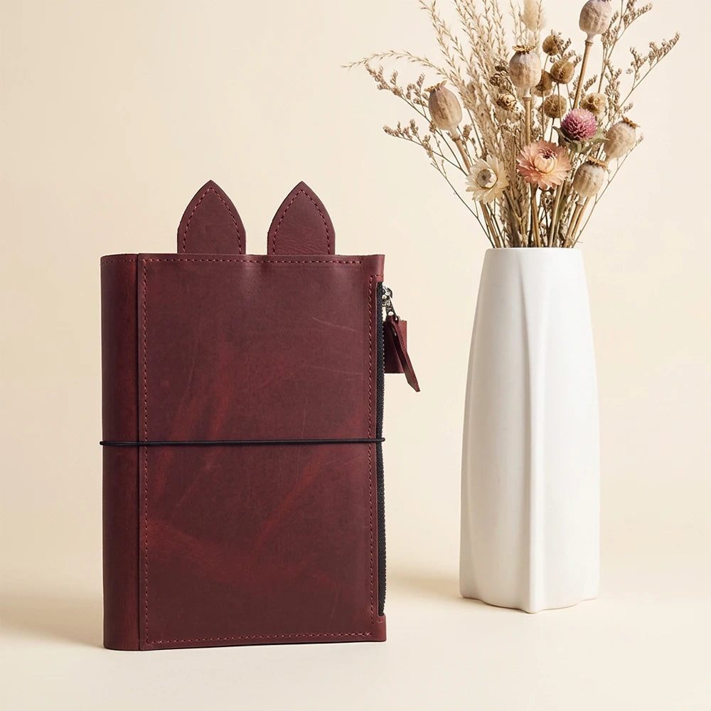 Handmade journal organizer featuring a large zippered compartment for storing small essentials.