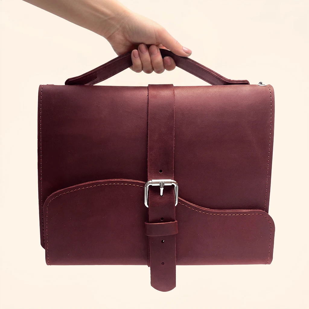 Functional leather journal case featuring three elastic loops for multiple paper inserts.