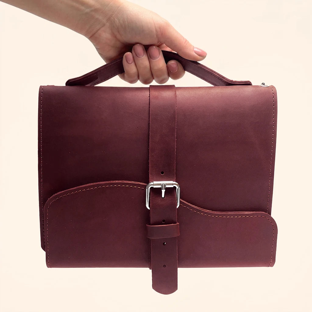 Handmade leather planner cover featuring three elastic loops and a convenient outer strap.