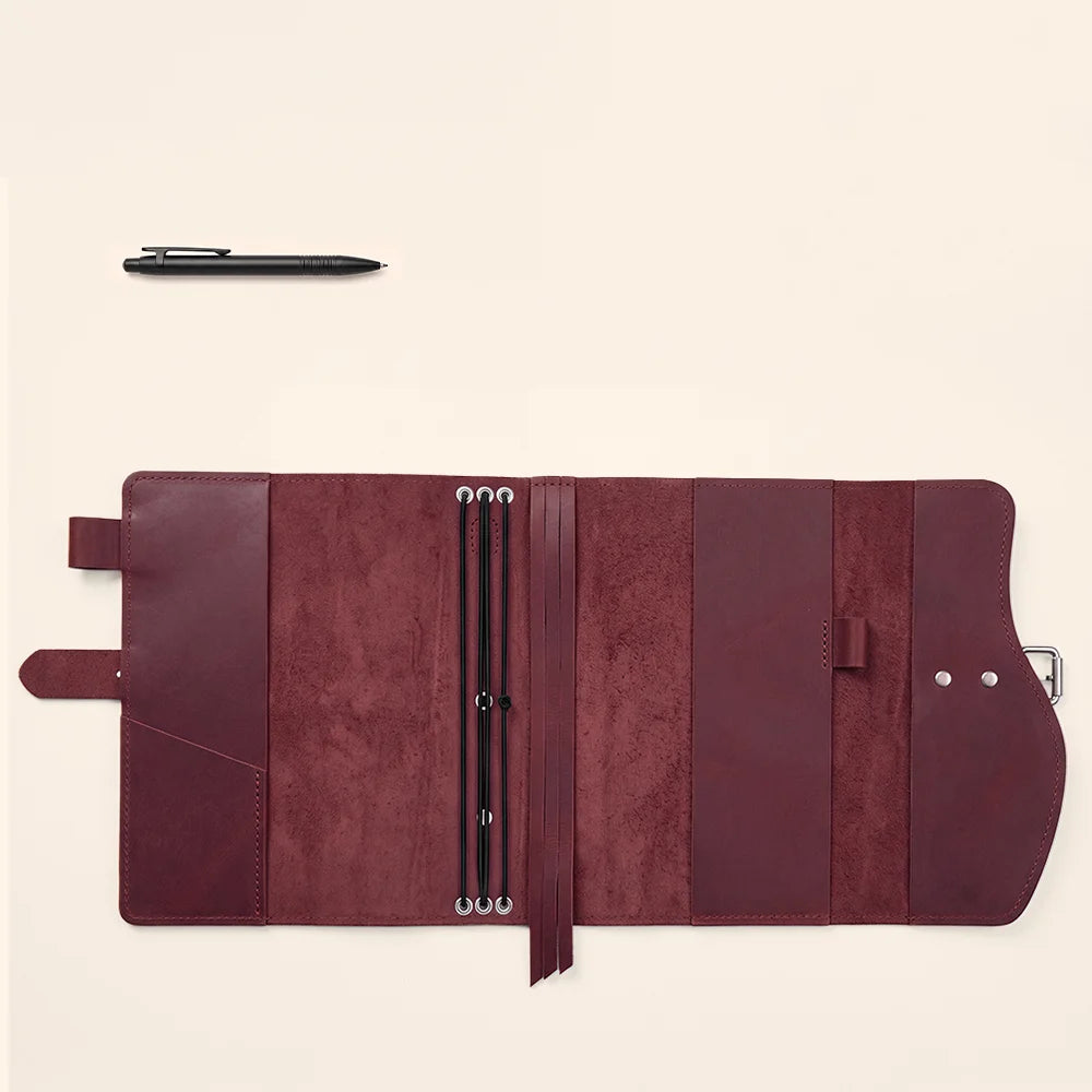 Leather planner case featuring interior pockets, pen loop, attached page marker, and carry handle