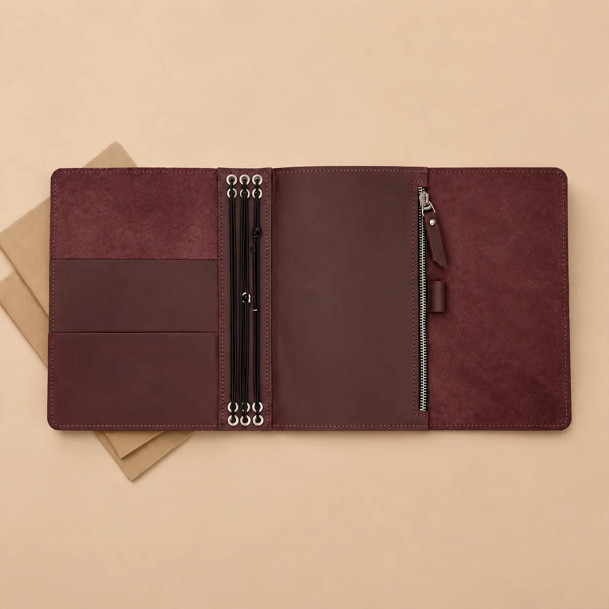 Burgundy genuine leather notebook cover with six elastic bands, pockets, zipper pocket, and pen loop.
