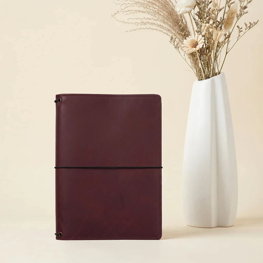 Leather notebook organizer with refillable design and spacious interior card storage.