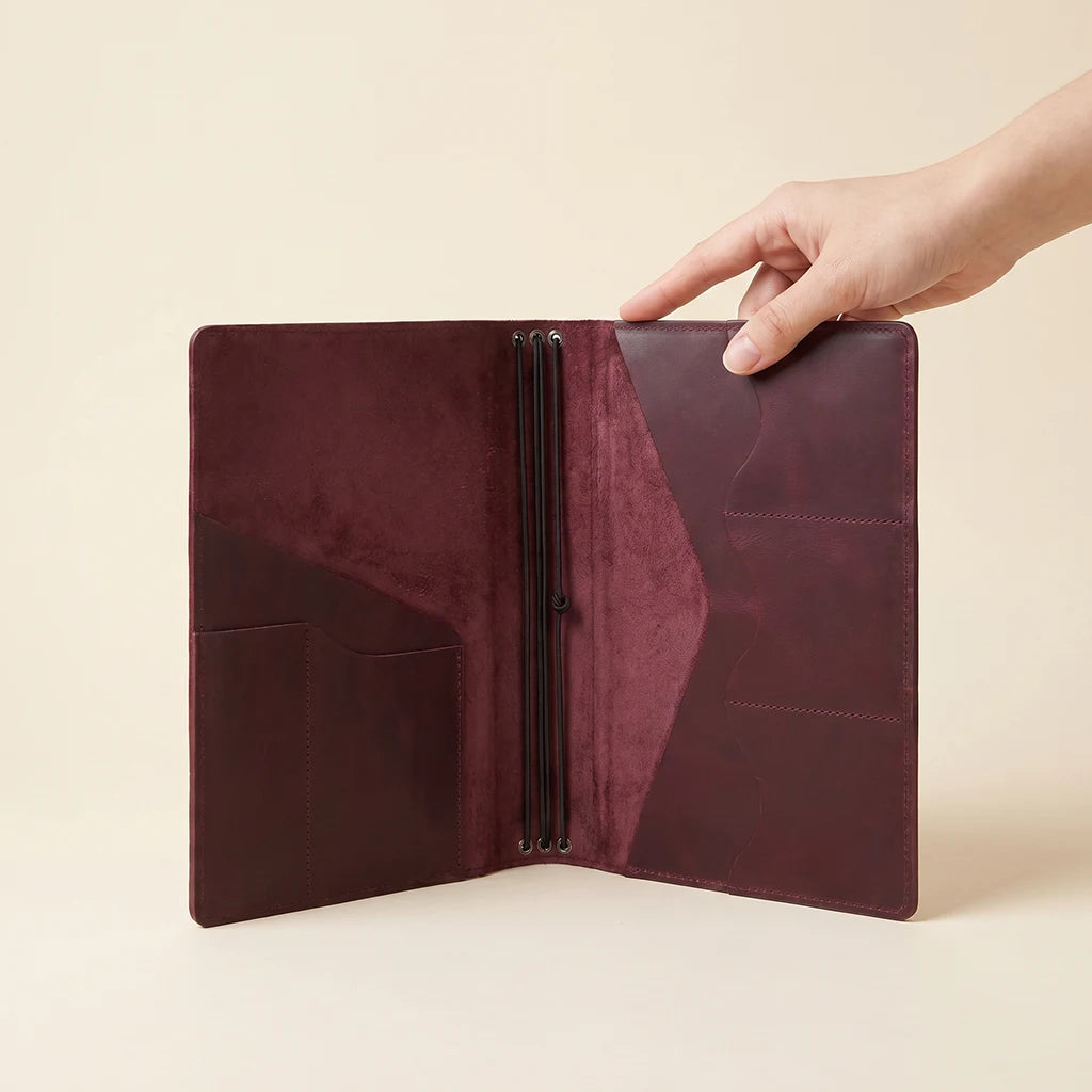 Leather refillable journal displaying detailed stitching and functional interior layout.