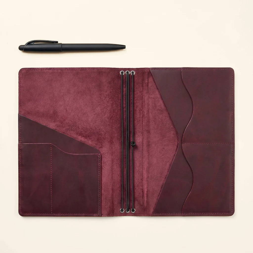 Brown leather notebook organizer designed for travelers, writers, and planners.