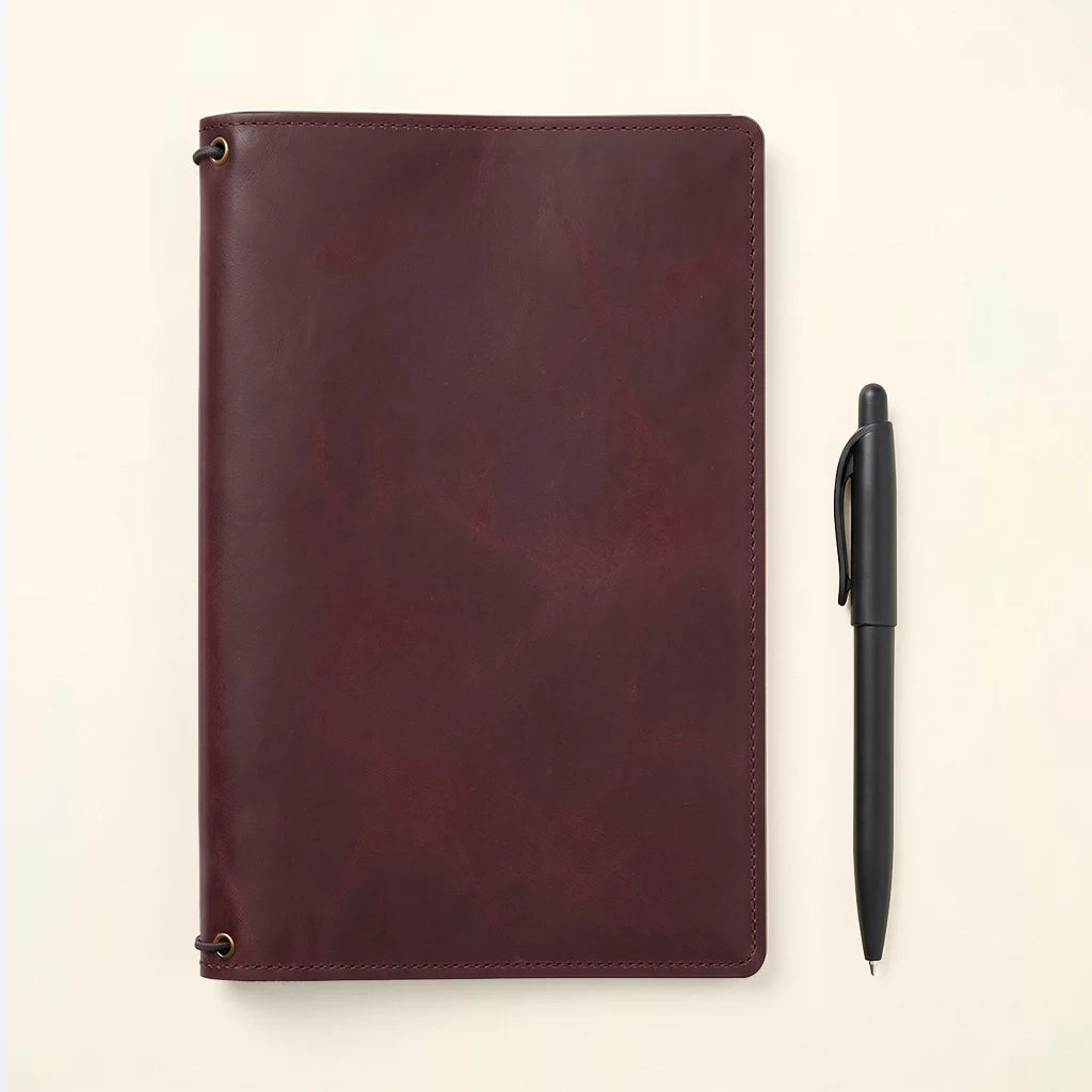 Leather notebook cover featuring organized interior and secure elastic notebook holders.
