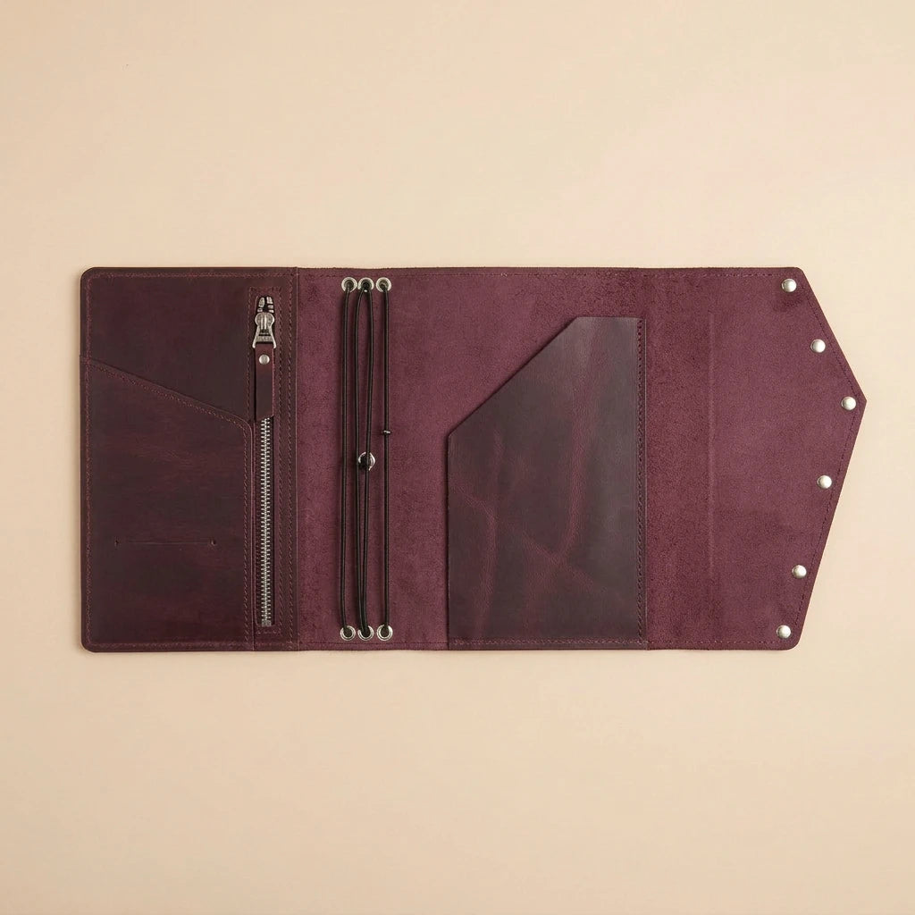 Brown leather journal with zipper on a beige background