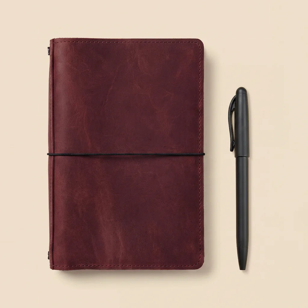 Premium leather notebook organizer with refillable insert system and handcrafted pocket details.