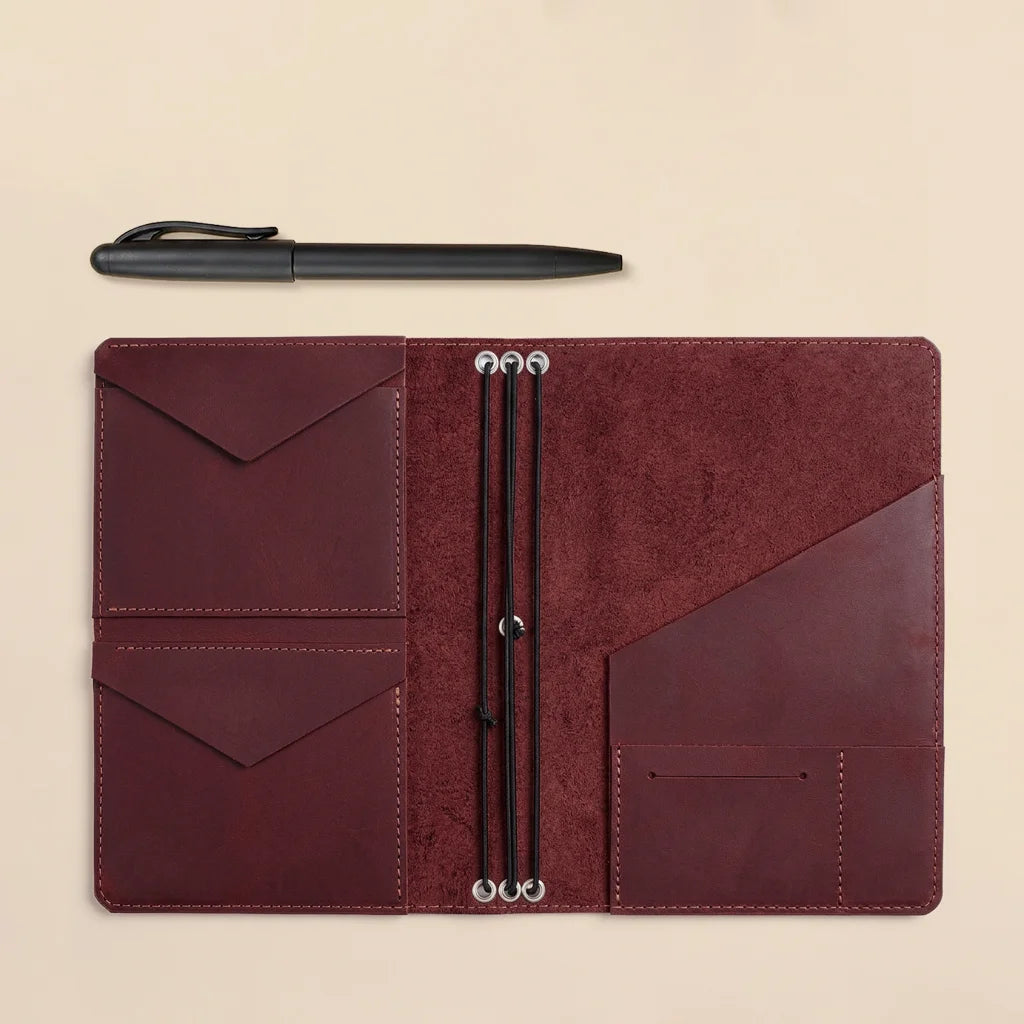 Handmade leather planner cover with durable elastic bands and practical interior pocket layout.