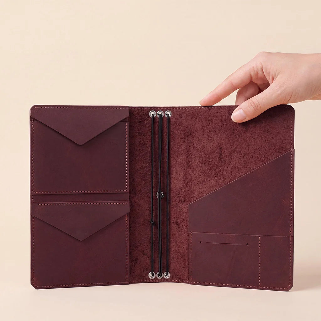 Handmade leather journal cover with secure elastic inserts and premium interior storage pockets.