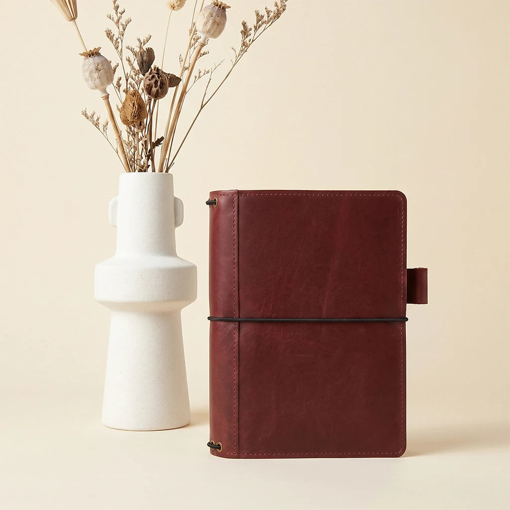Leather journal holder designed with pockets and secure elastic notebook bands