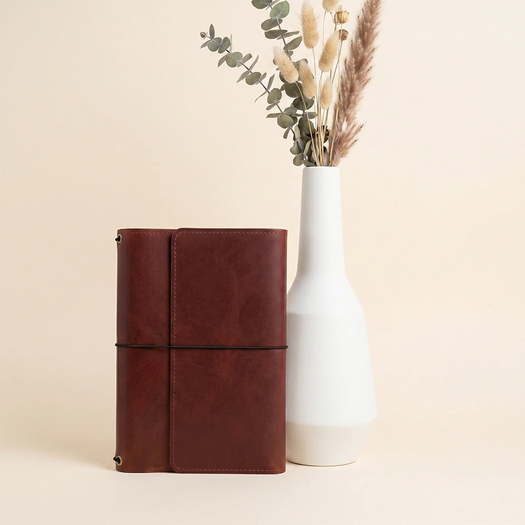 Handmade leather notebook cover featuring timeless craftsmanship and refillable functionality.