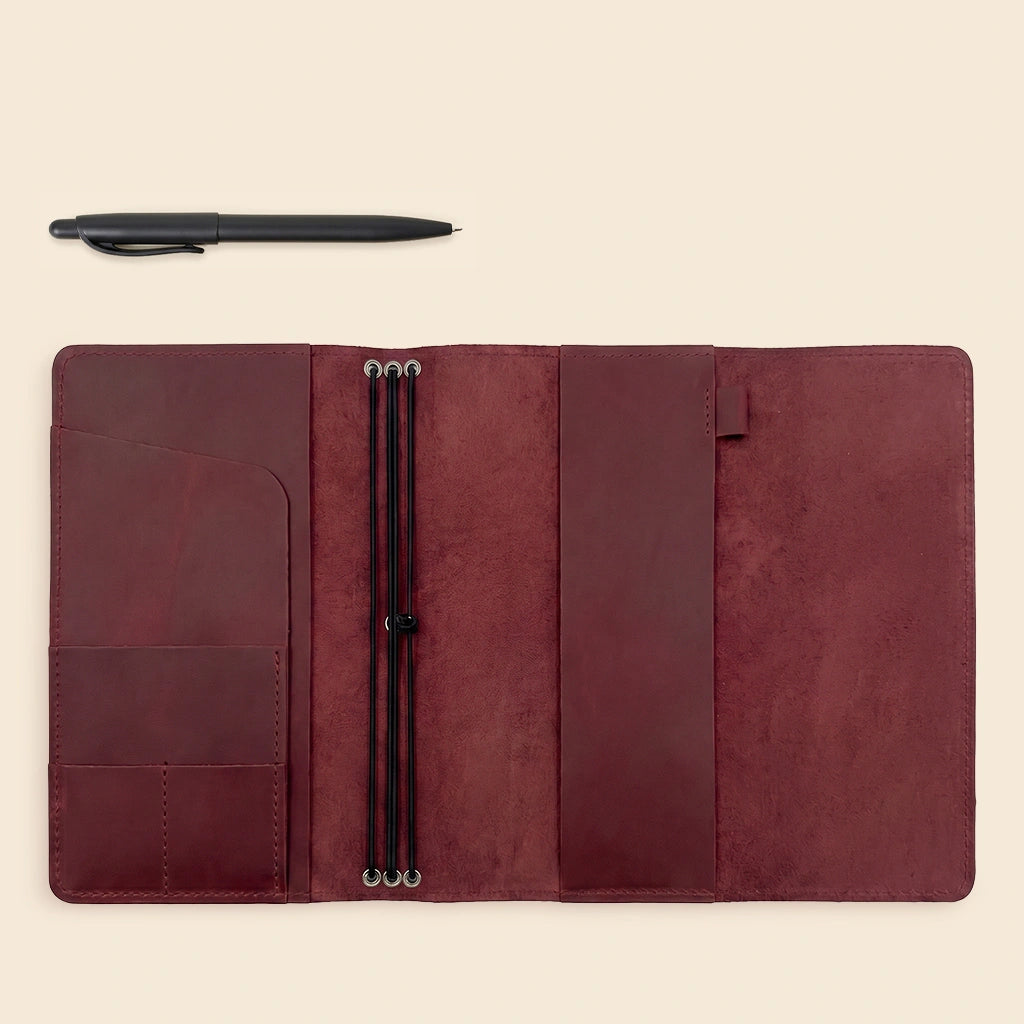 Leather notebook cover made from natural leather with flexible journal retaining elastics.