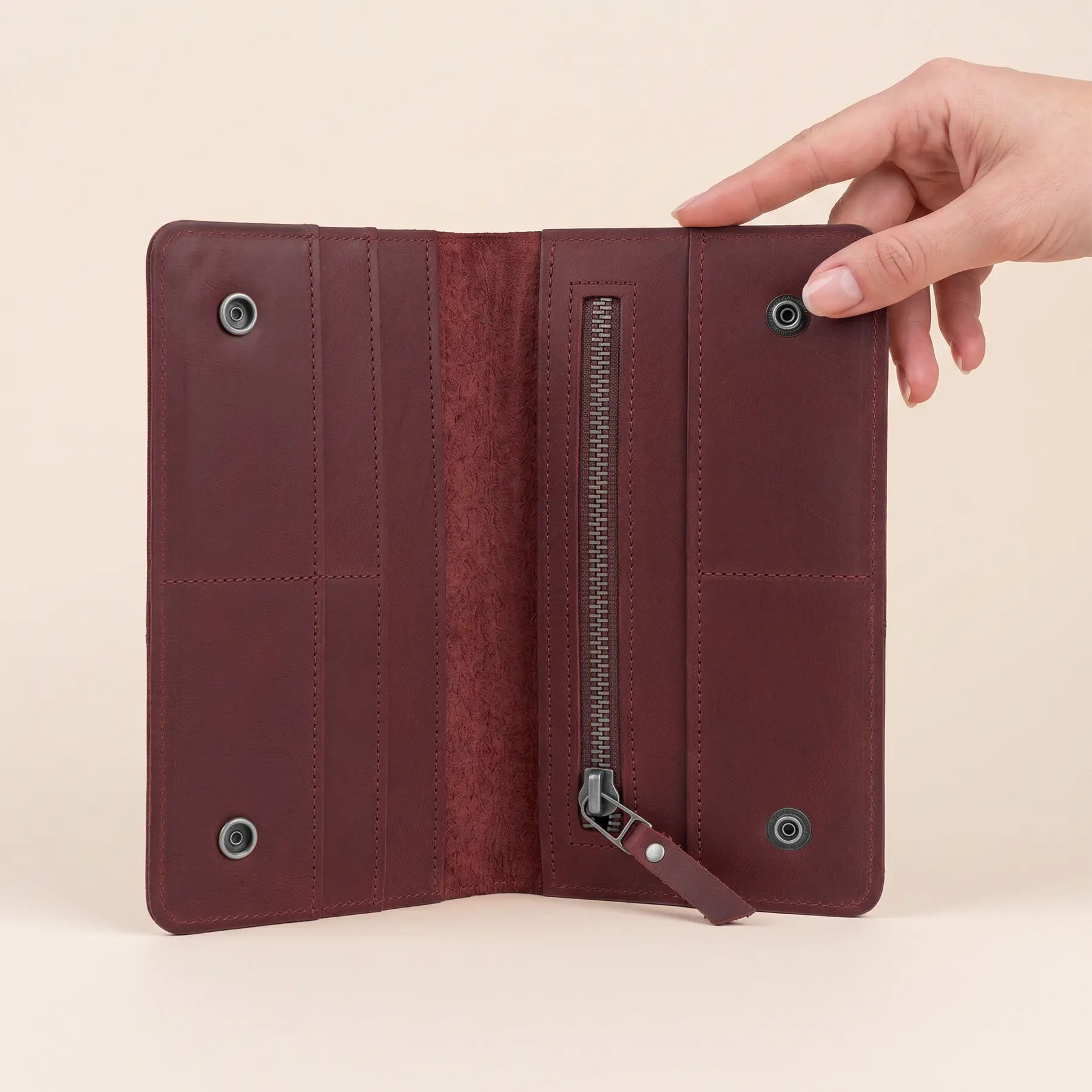 Full grain leather wallet with secure snap closure, interior zipper pocket, and card organizers.