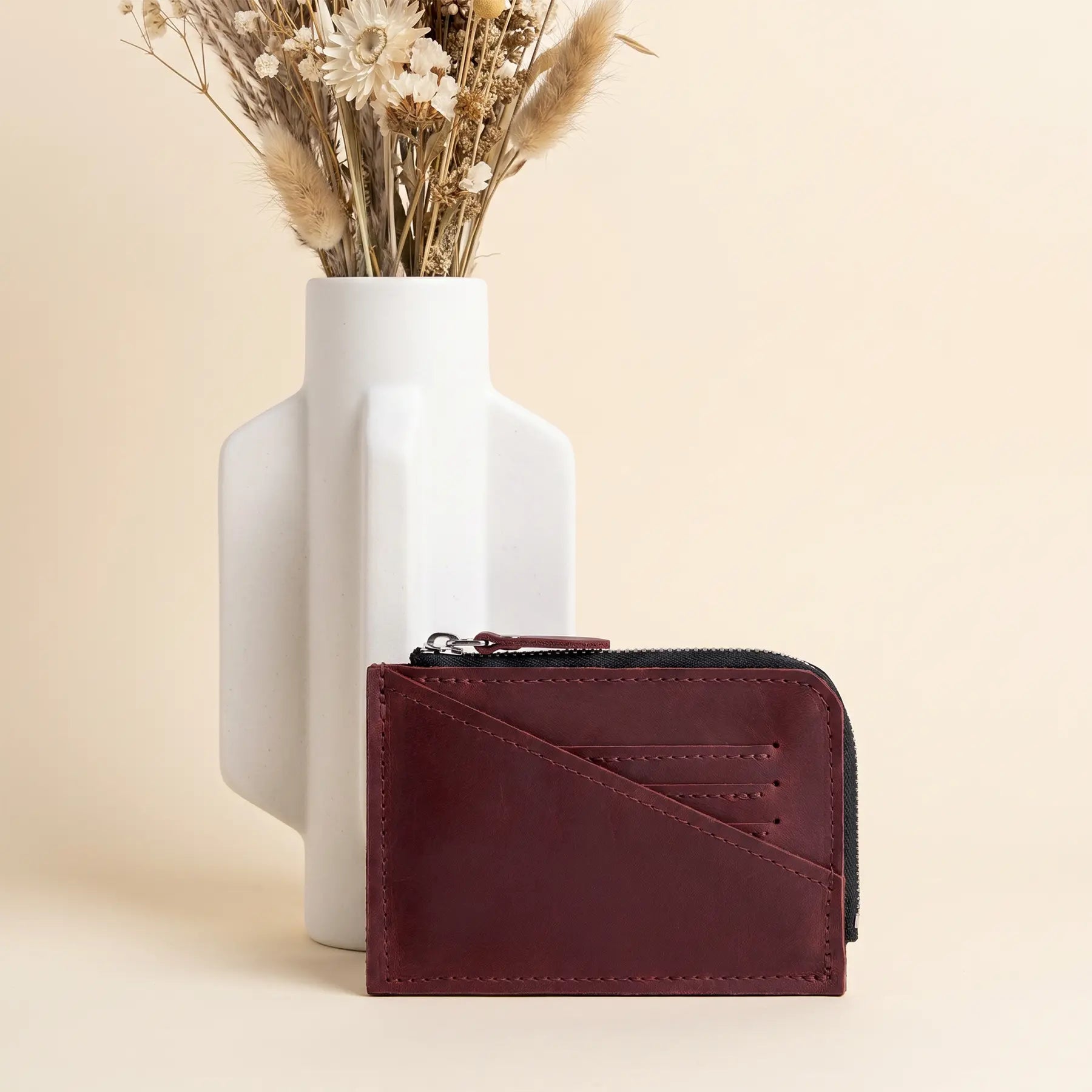 Compact leather coin purse with zipper closure and timeless handmade craftsmanship from genuine leather.