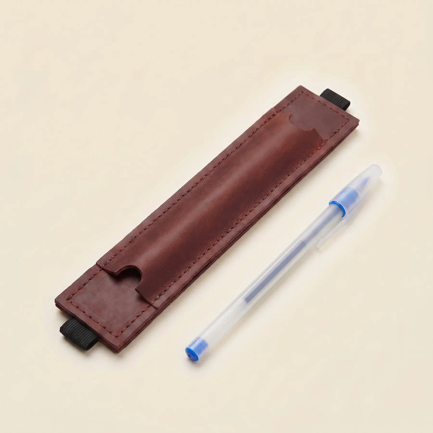Elegant leather pen loop with elastic notebook band for convenient everyday carry.