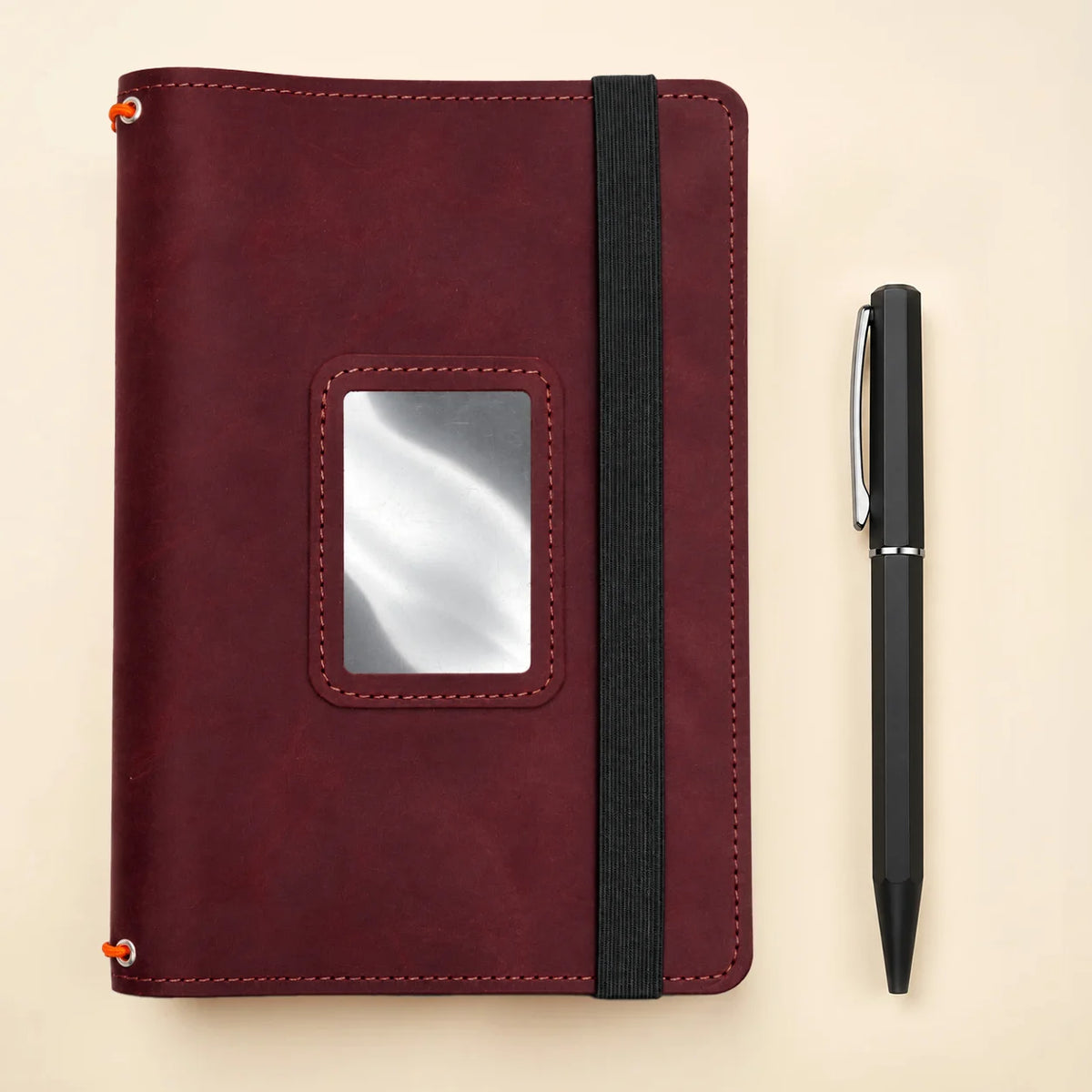 Handmade leather notebook organizer with three elastic straps and several built-in inner pockets.