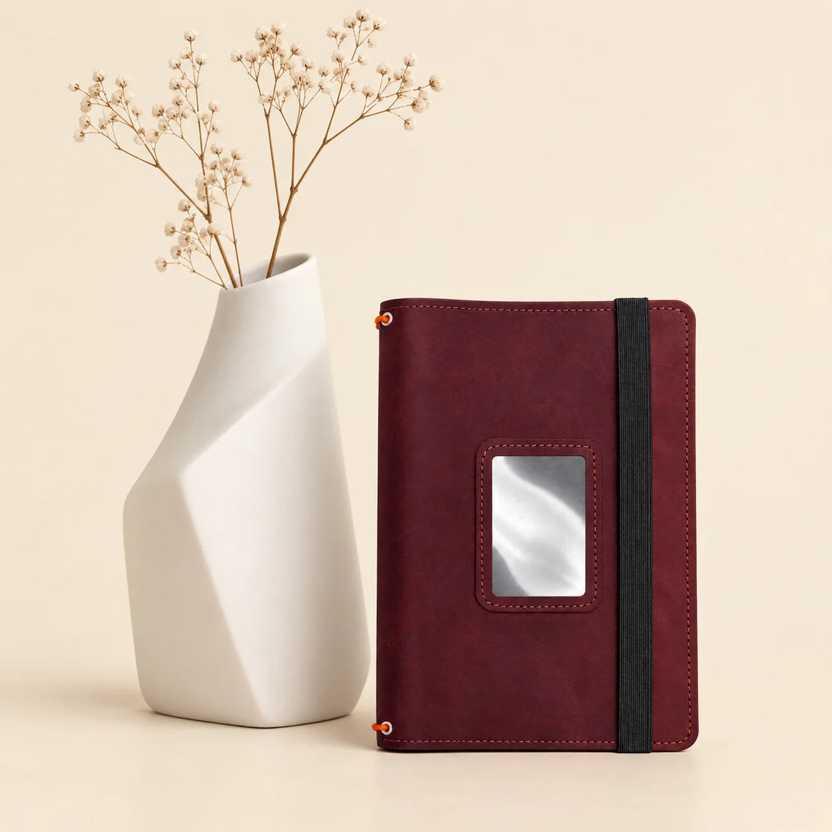 Natural leather notebook cover featuring three elastic bands and several interior pockets.
