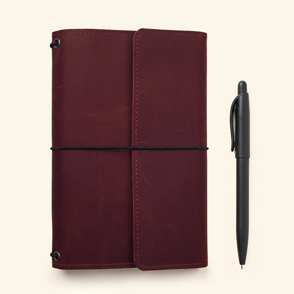Genuine leather notebook holder combining timeless craftsmanship with practical interior storage options.