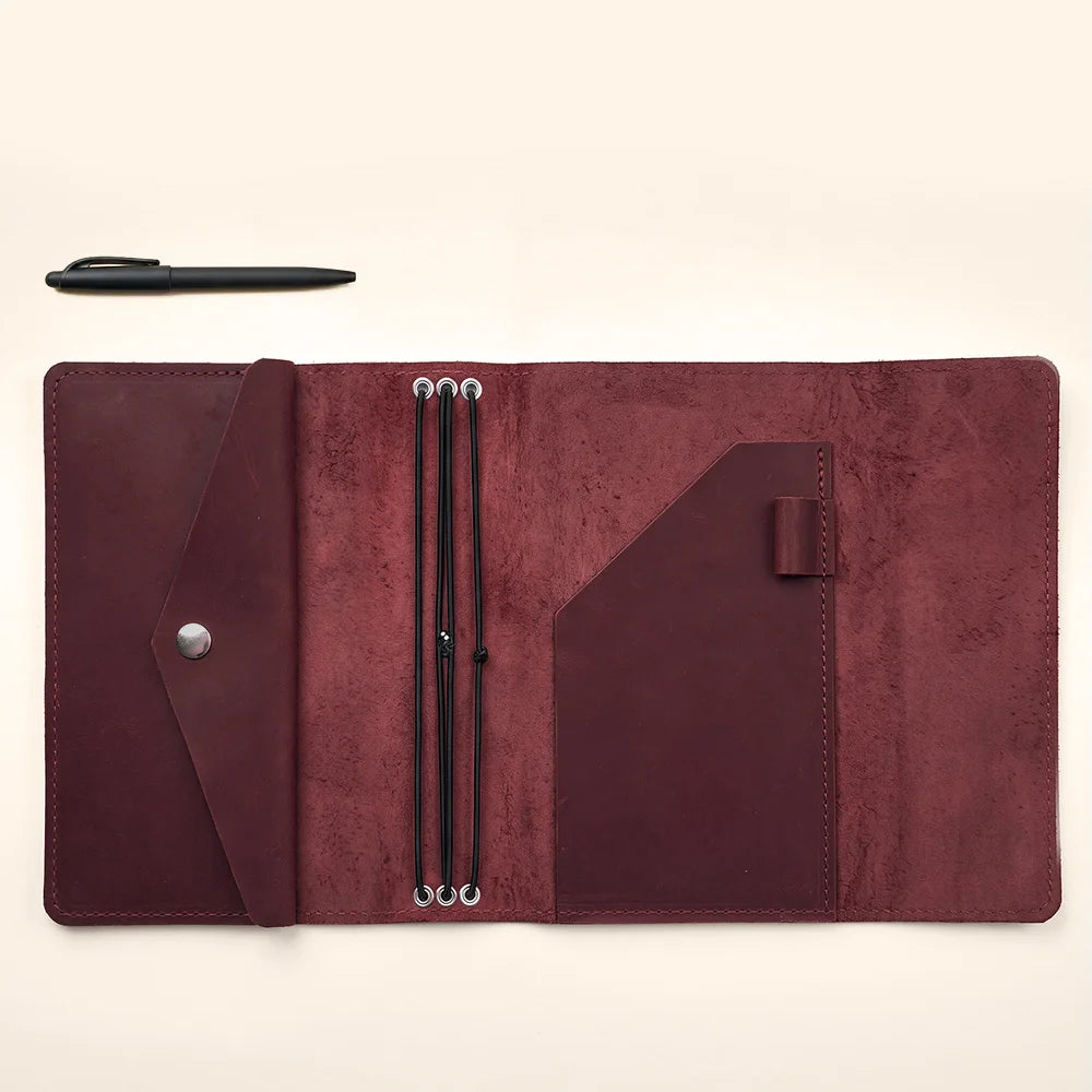 Elegant leather planner cover combining timeless craftsmanship with practical notebook organization features.