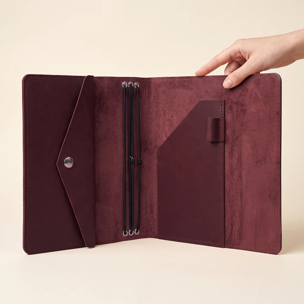 Refillable leather notebook organizer with smooth finish and thoughtfully arranged interior pockets.
