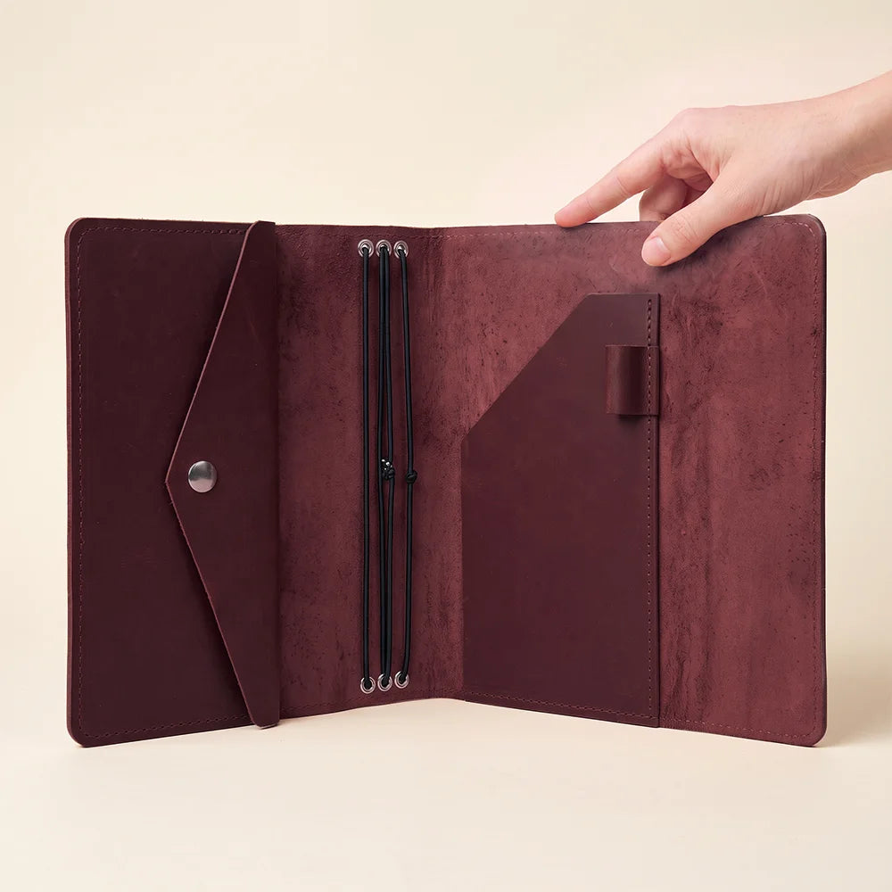 Full grain leather notebook organizer with elastic insert system and spacious interior pockets.