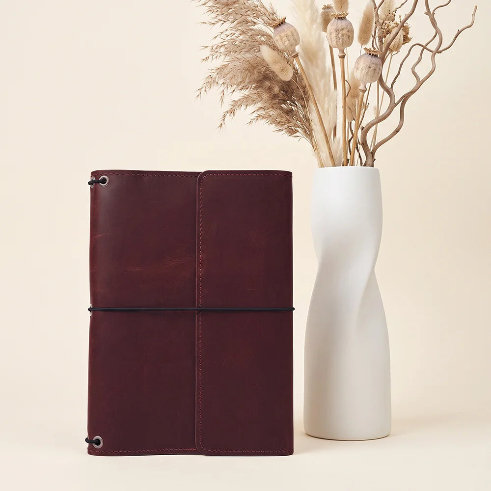 Elegant refillable notebook cover crafted from genuine leather with practical inside organization.
