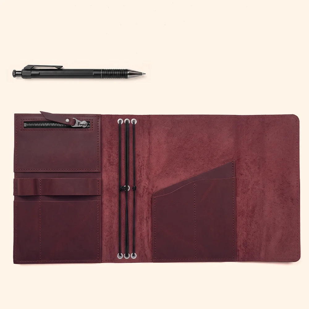 Handmade notebook case crafted from genuine leather with practical storage sections inside.