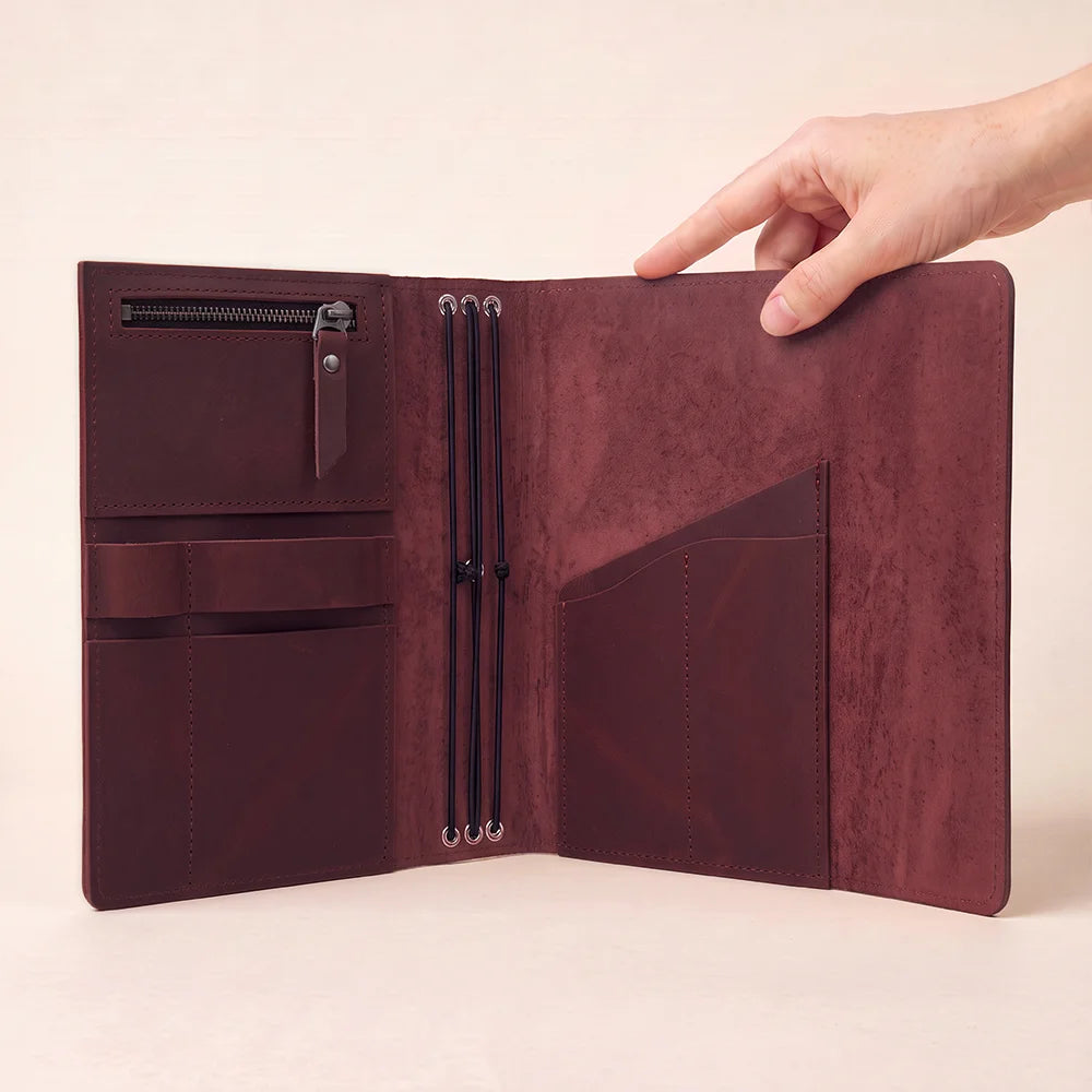 Genuine leather journal cover with carefully crafted pockets and an integrated writing accessory holder.