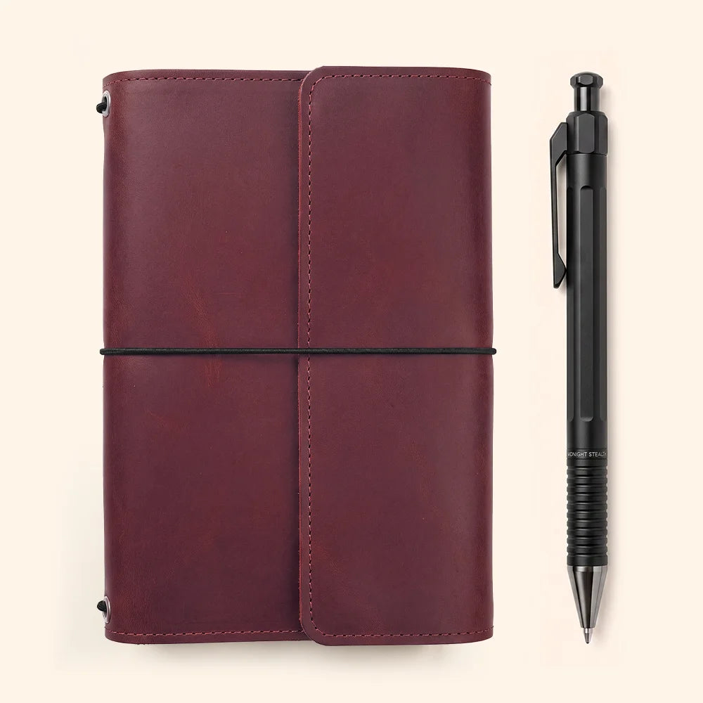 Durable leather journal cover featuring interior pockets and a convenient elastic pen loop