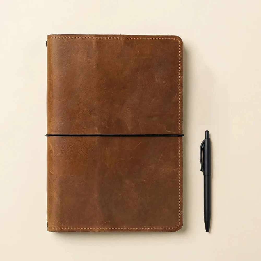 Classic leather notebook holder with interior storage compartments and refillable elastic notebook system.