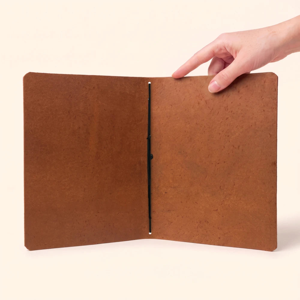 Genuine leather writing cover with a single elastic loop supporting the notebook insert.