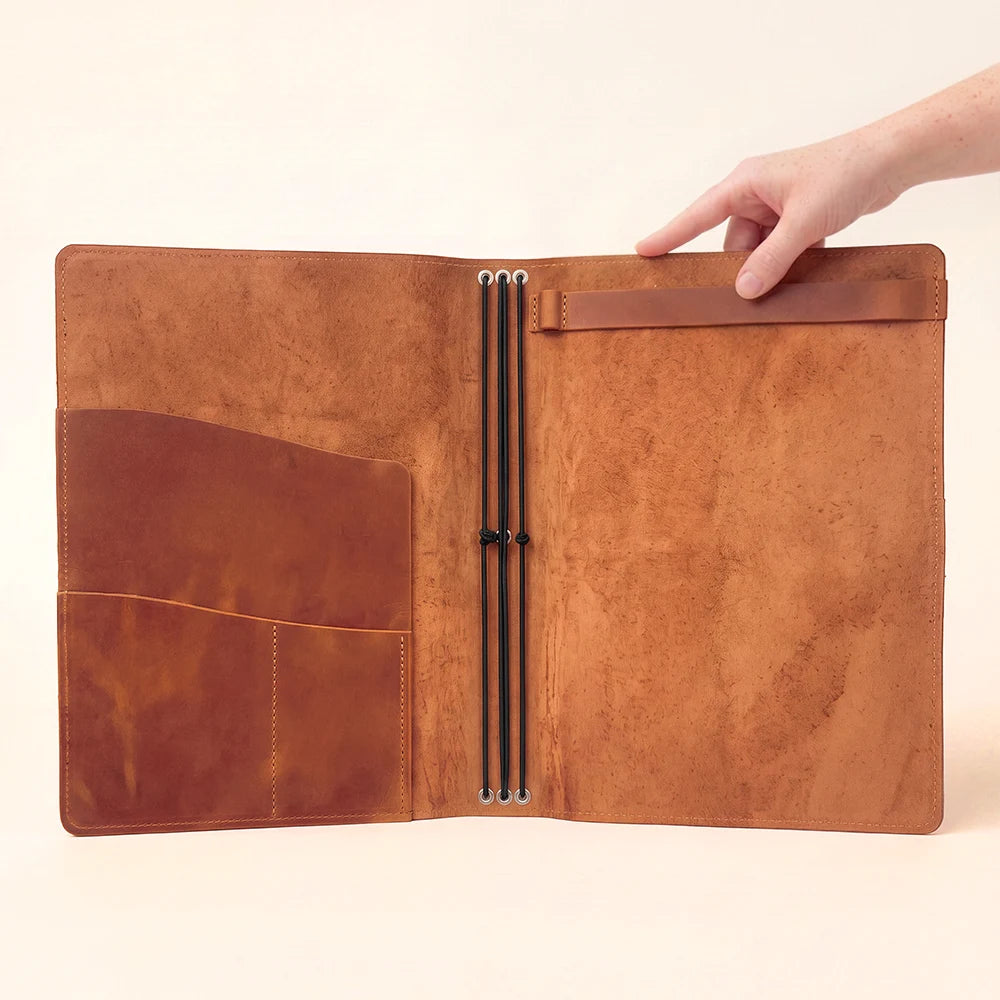 Leather notebook wrap offering dedicated storage for notes, cards, and creative materials.