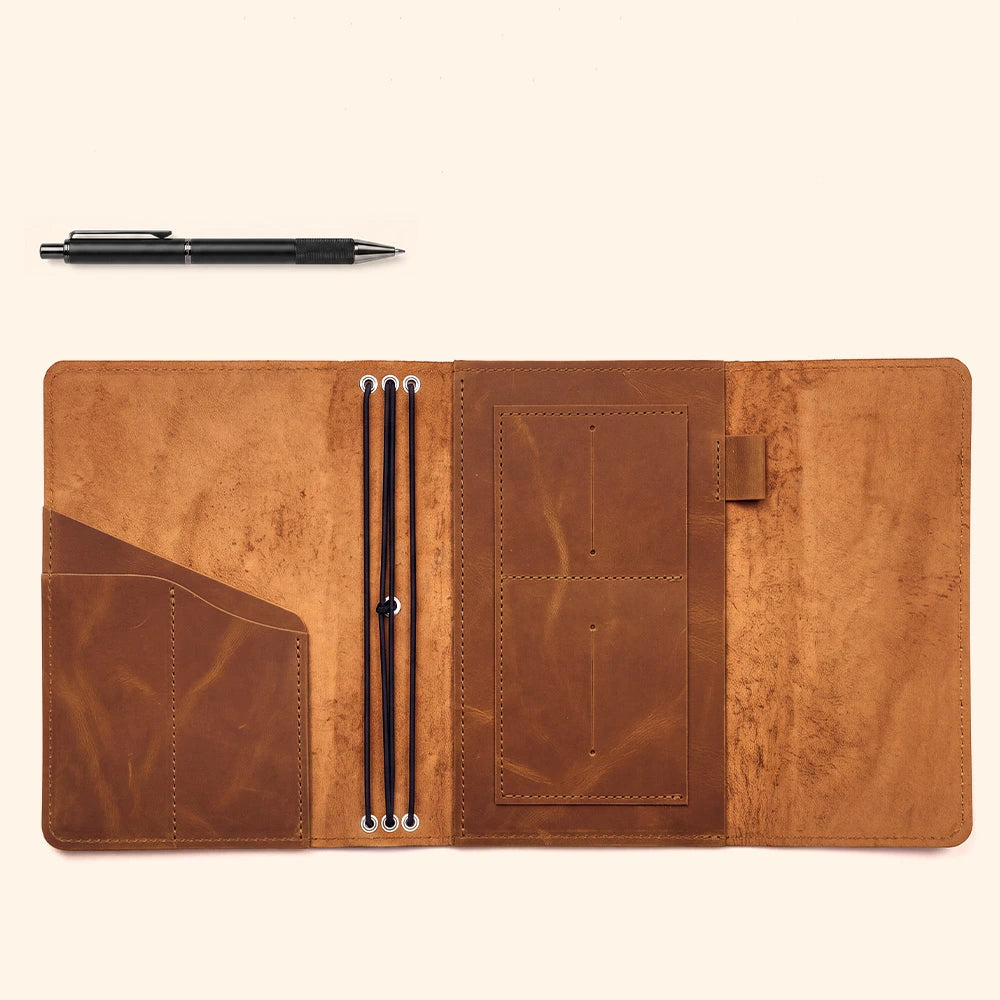 Leather notebook carrier with practical storage layout and secure leather pen retaining feature.