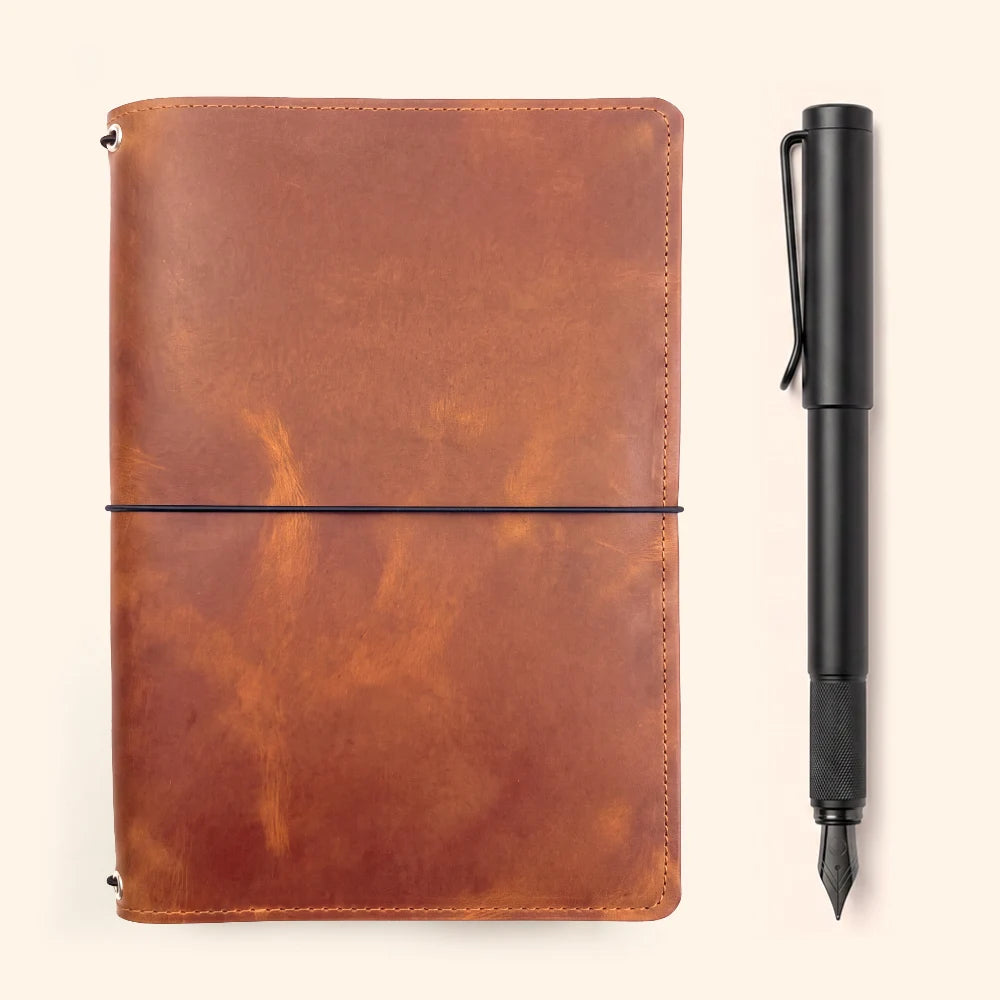 Handmade leather cover with three elastic loops for keeping notebook refills organized.
