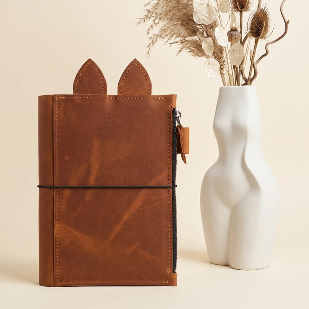 Brown refillable notebook organizer designed with spacious storage and convenient pen placement.