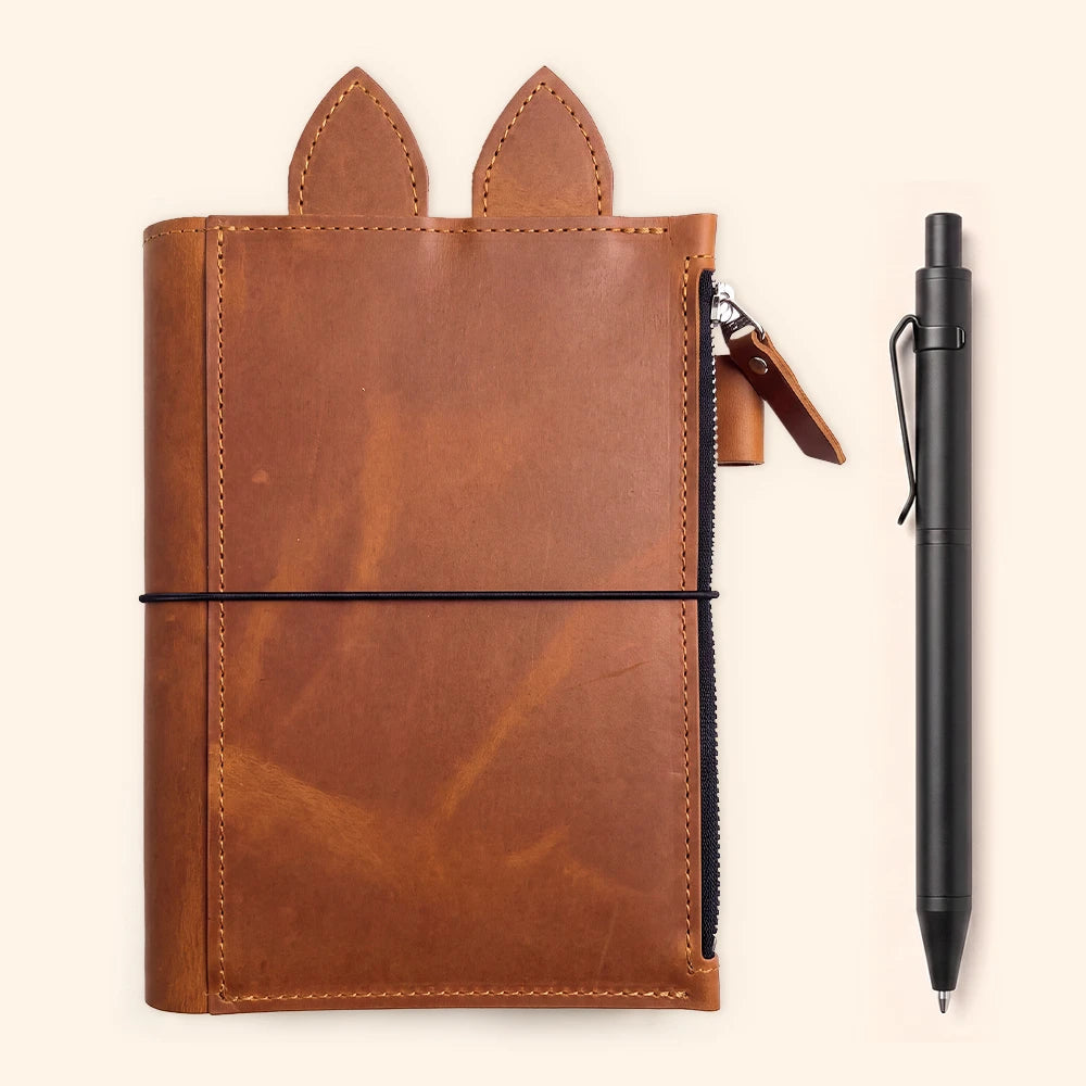 Genuine leather travel planner cover with zippered compartment, pen loop, leather ears, and elastic bands.