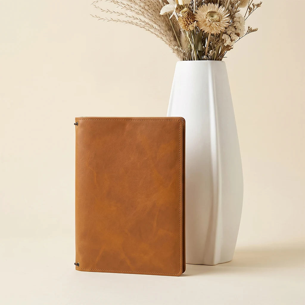 Refillable journal cover combining timeless leather craftsmanship with modern functionality.