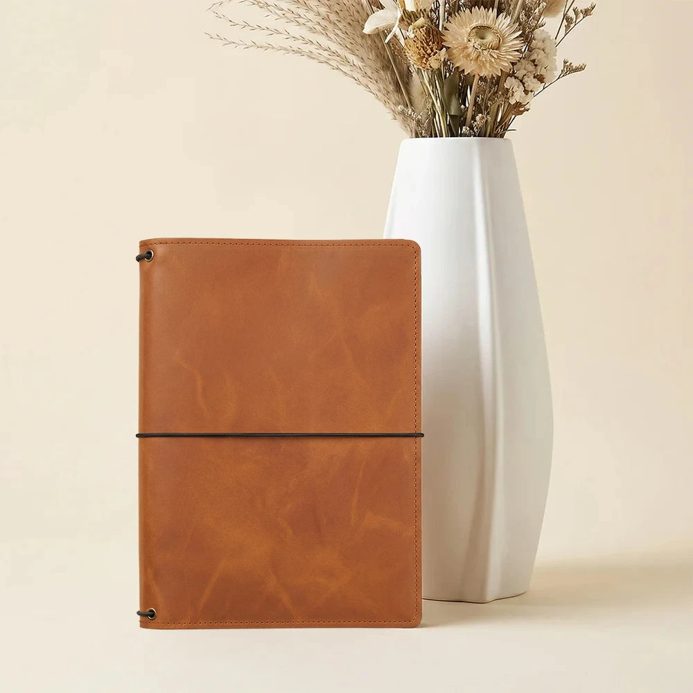 Premium leather notebook wallet featuring organized compartments and refillable elastic notebook system.
