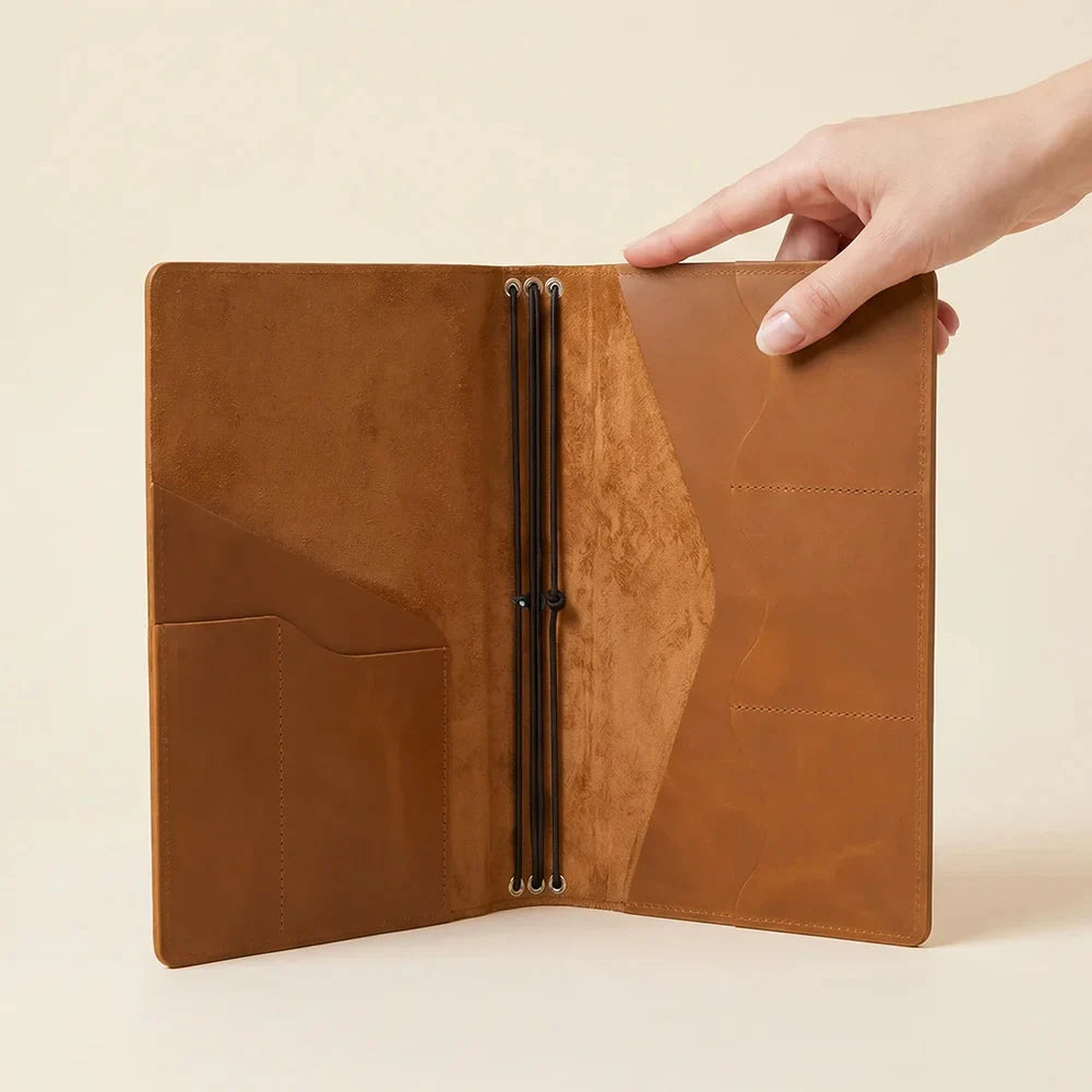 Genuine leather notebook sleeve with interior organization and three elastic journal holders.