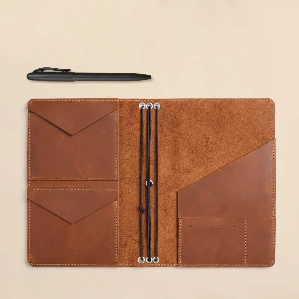 Genuine leather planner organizer with built-in storage sleeves and durable elastic notebook cords.