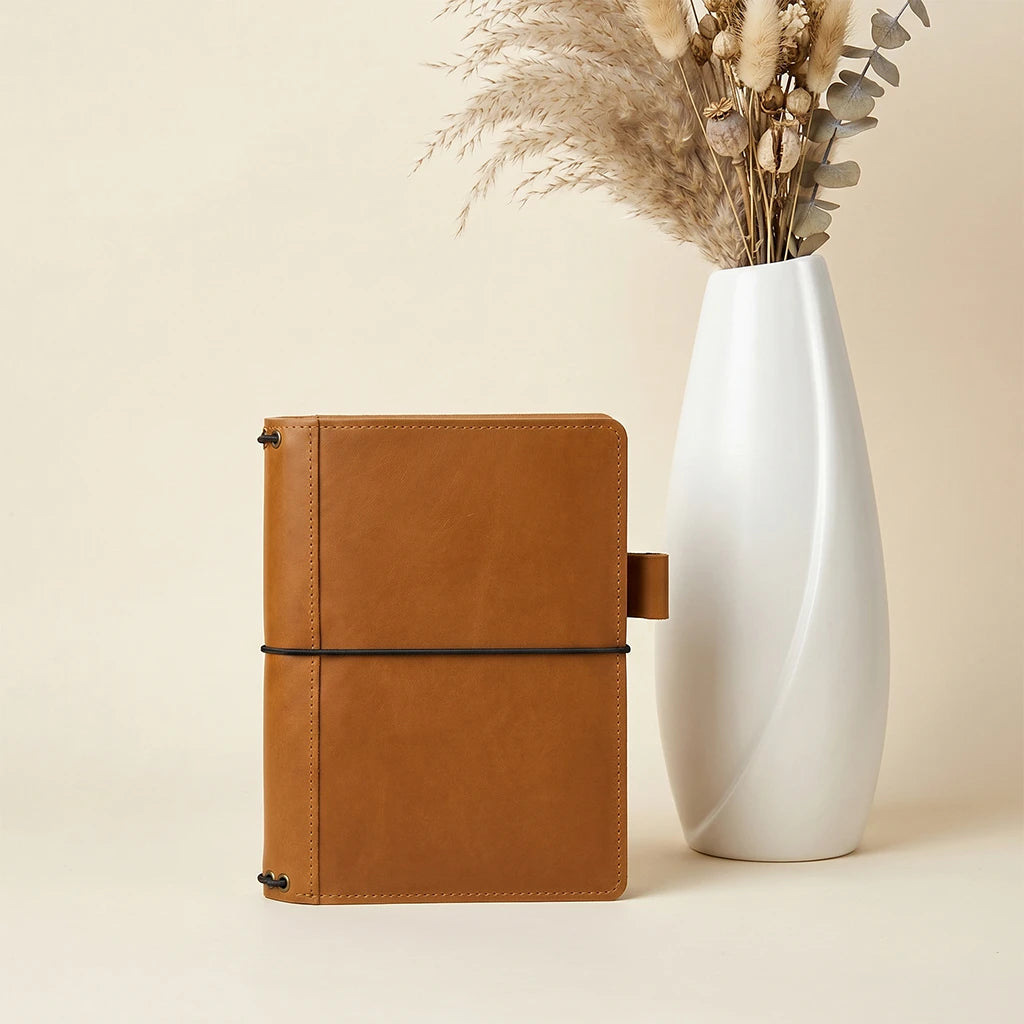 Leather travel journal organizer featuring pen holder and interior pocket storage