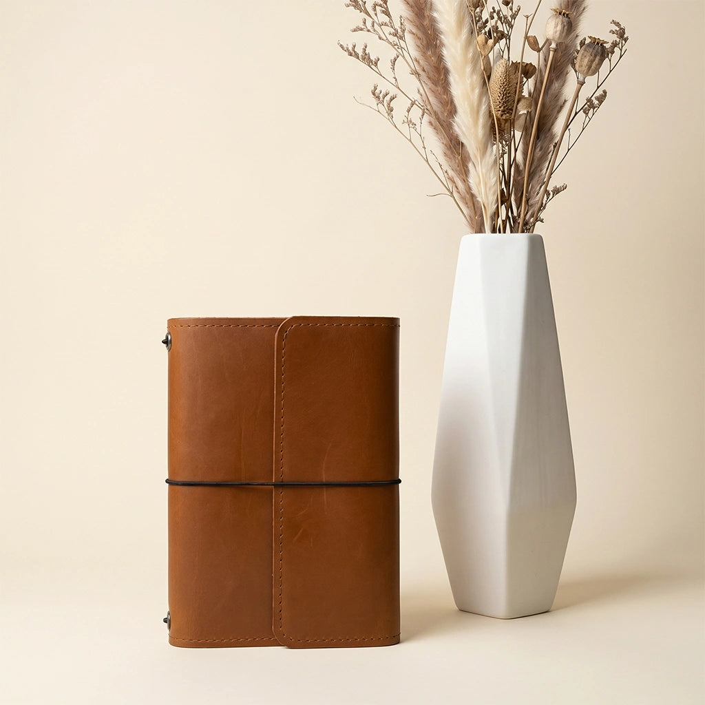 Handmade leather notebook case with premium leather finish and integrated pen holder.