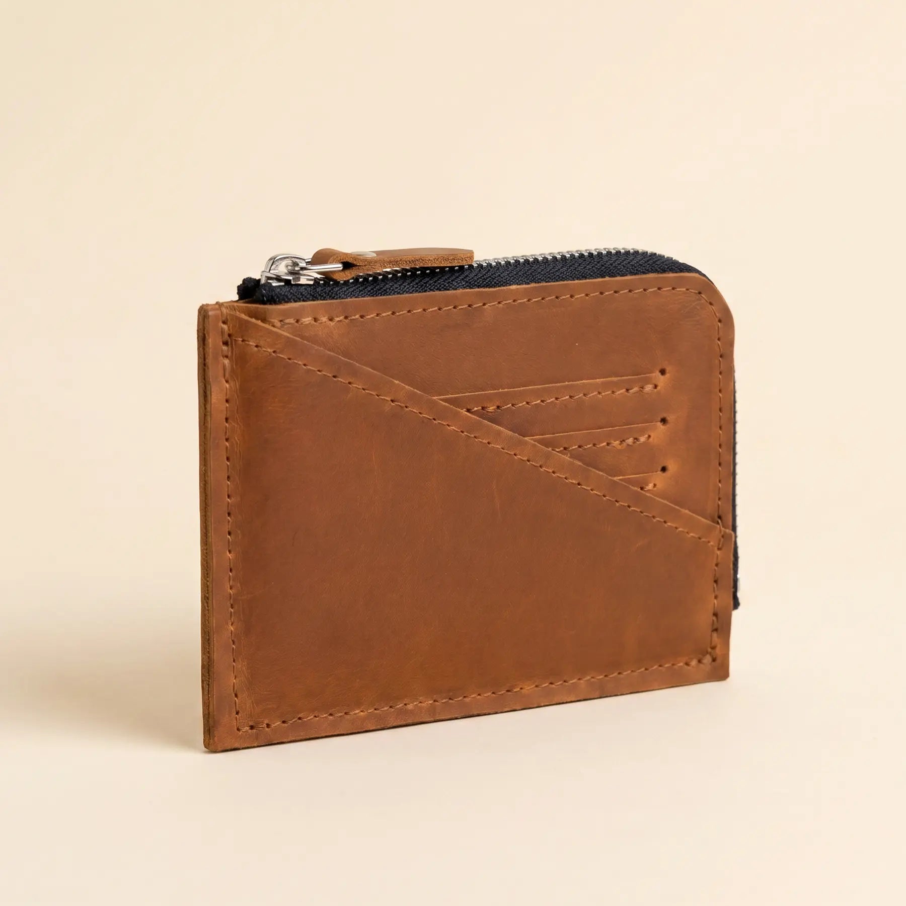 Compact leather wallet with smooth zipper, perfect for cash, coins, and everyday essentials.