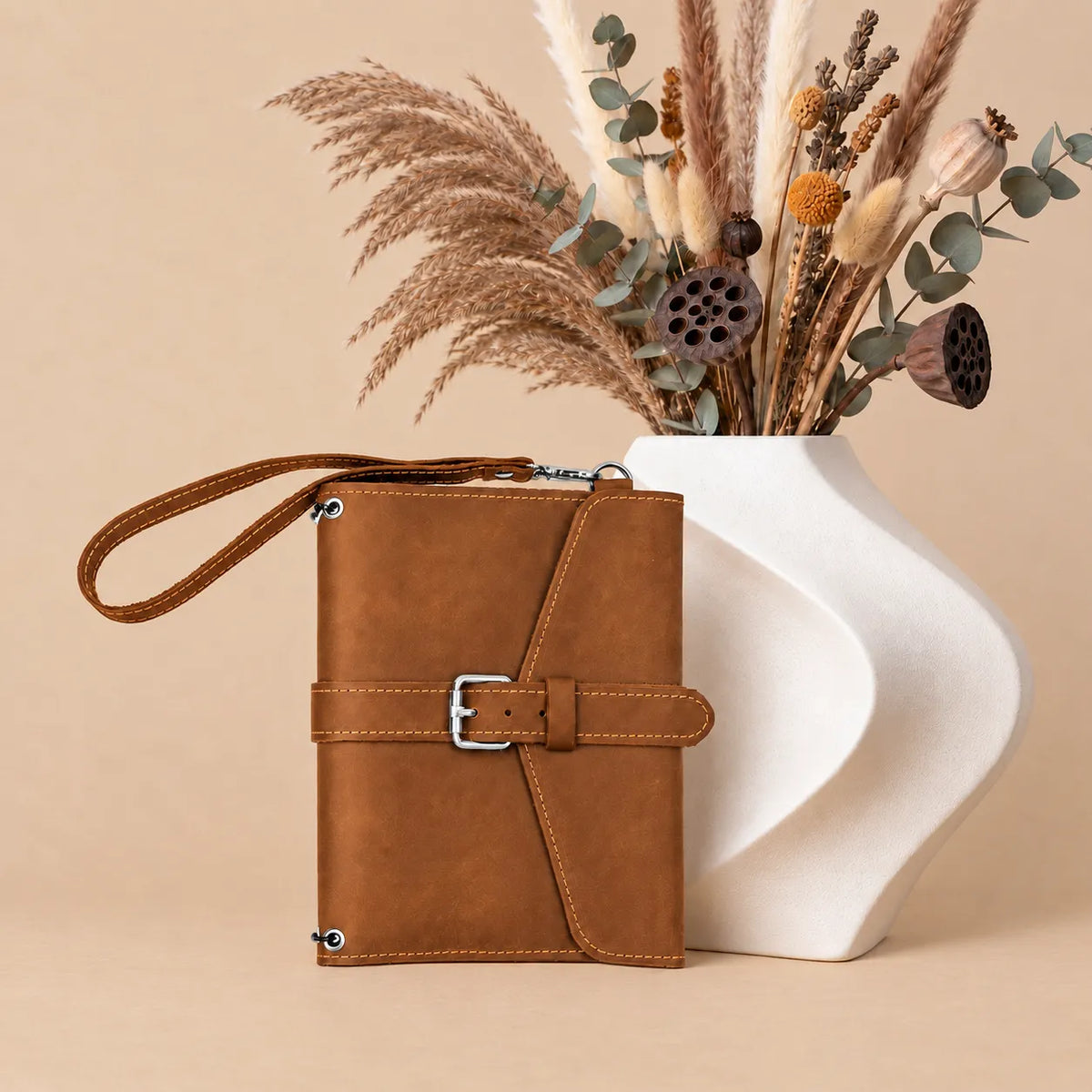 Genuine leather journal cover with spacious pockets and comfortable wrist carrying strap