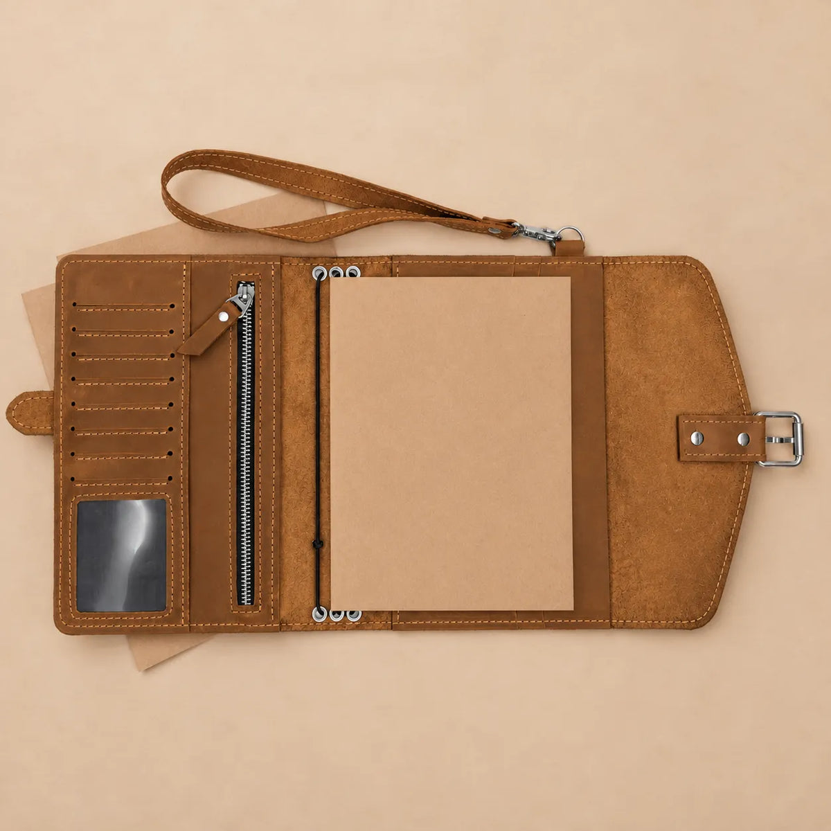 Handmade Crazy Horse leather notebook sleeve with interior pockets and wrist strap