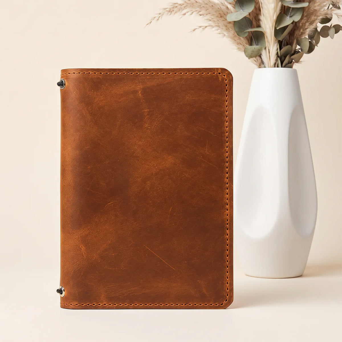 Handcrafted natural leather notebook sleeve with paired elastic holders and integrated storage pockets