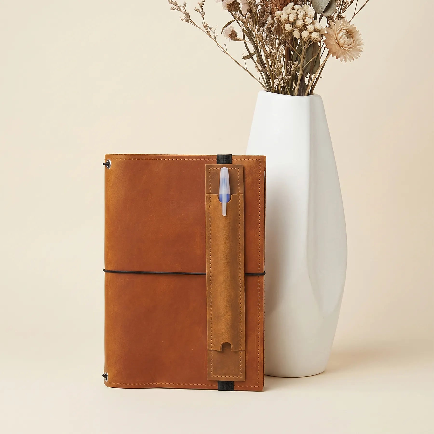 Premium leather pen holder compatible with journals, planners, and hardcover notebooks everywhere.