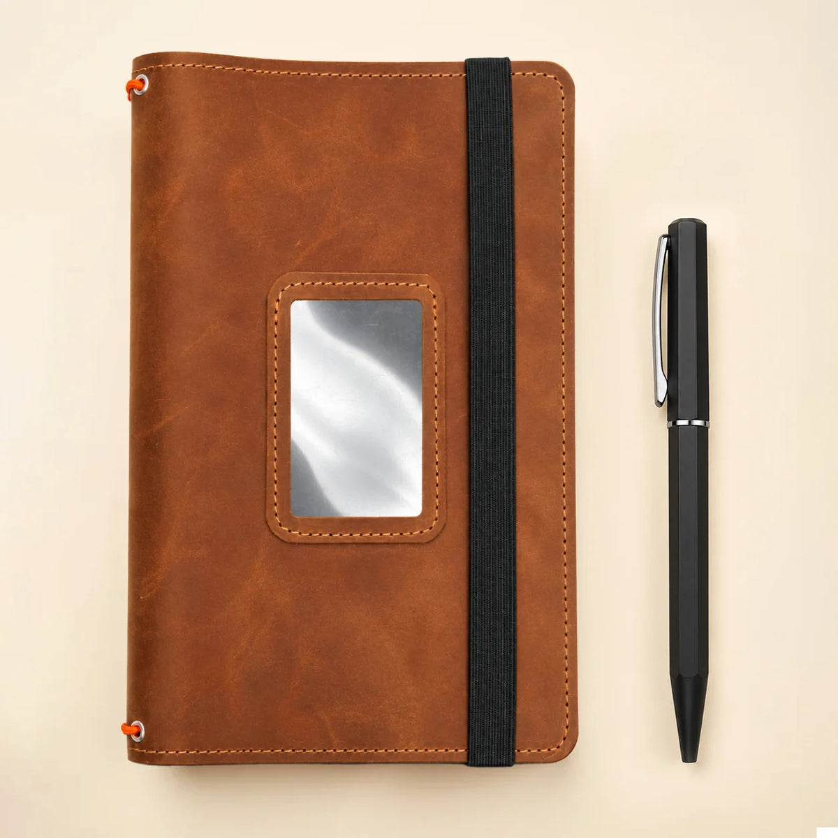 Natural leather journal organizer with three notebook bands and several practical interior compartments.