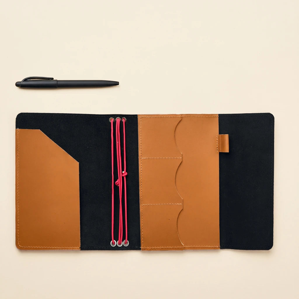Handmade leather writing cover with elastic straps and secure accessory compartments